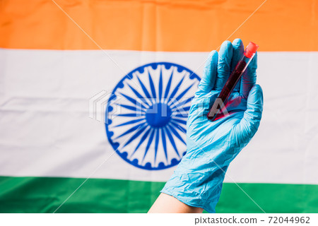 Hands of doctor wearing gloves holding blood test tube coronavirus 72044962