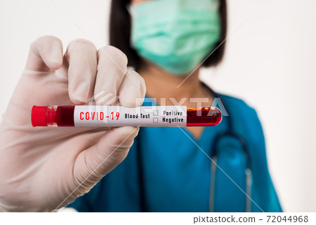 Nurse in blue uniform wear a mask holding test tube sample Coronavirus test blood Nurse in blue uniform wear a mask holding test tube sample Coronavirus test blood 72044968