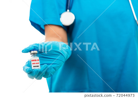 woman doctor in blue uniform holding COVID-19 vaccine 72044973