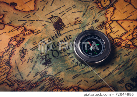 Old compass discovery on vintage paper antique world map 72044996