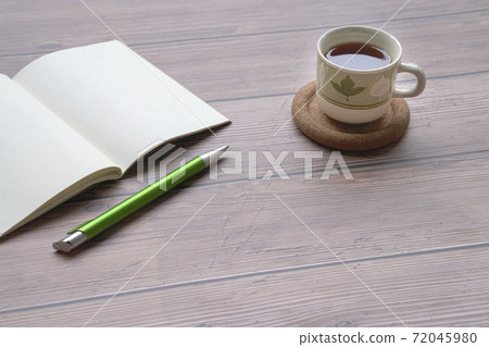 Coffee, open notepad and pen on wood table. Coffee, open notepad and pen on wood table. 72045980