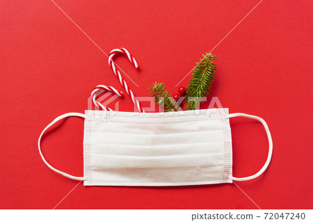 Measures against infectious diseases in winter. Christmas decorations and fir branches and masks Measures against infectious diseases in winter. Christmas decorations and fir branches and masks 72047240