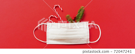Measures against infectious diseases in winter. Christmas decorations and fir branches and masks Measures against infectious diseases in winter. Christmas decorations and fir branches and masks 72047241