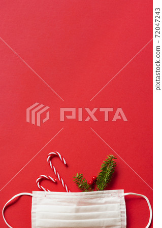 Measures against infectious diseases in winter. Christmas decorations and fir branches and masks Measures against infectious diseases in winter. Christmas decorations and fir branches and masks 72047243