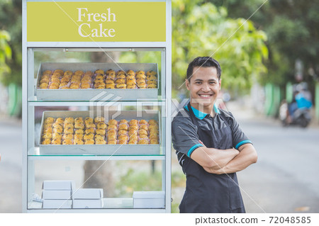small business owner and his food stall 72048585