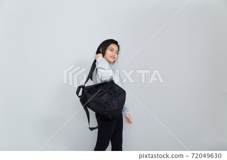 Asian little girl with backpack on grey background 72049630