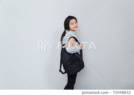 Asian little girl with backpack on grey background 72049632