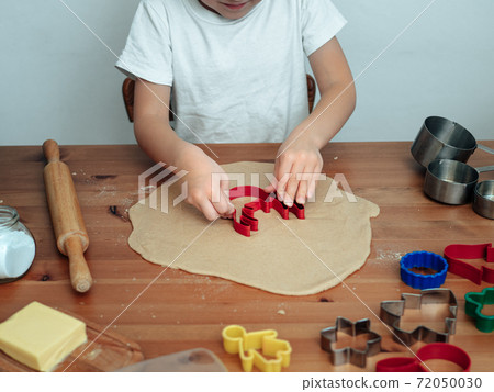 Son in kitchen making cookies 72050030