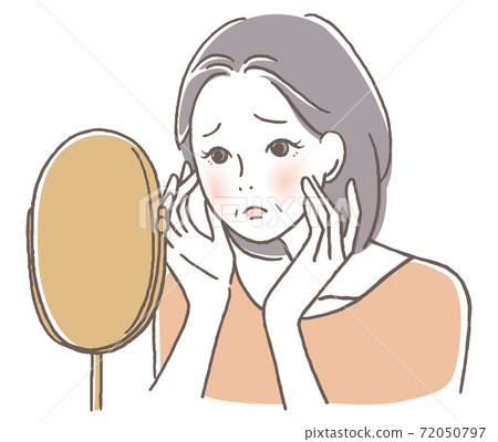 Senior woman worried looking in the mirror 72050797