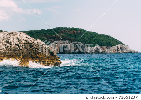 A cave in a rock on the Lustica Peninsula, in Montenegro. A cave in a rock on the Lustica Peninsula, in Montenegro. 72051237