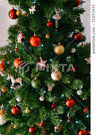 Beautiful Christmas tree decorated with toys and balls. Beautiful Christmas tree decorated with toys and balls. 72051435