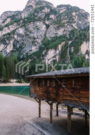 Wooden boat dock hut on the Lago di Braies on the background of rocky mountains and forests. Braies lake in the Dolomites in South Tyrol, Italy, a municipality of Braies, in the Prague Valley. Wooden boat dock hut on the Lago di Braies on the background of rocky mountains and forests. Braies lake in the Dolomites in South Tyrol, Italy, a municipality of Braies, in the Prague Valley. 72051441