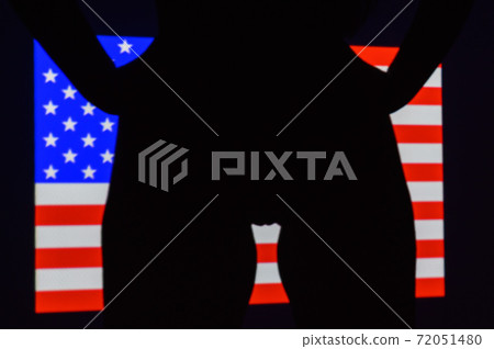 The projection of the flag of the United States of America on a beautiful large female ass. The projector shines with a flag on a female body. The projection of the flag of the United States of America on a beautiful large female ass. The projector shines with a flag on a female body. 72051480