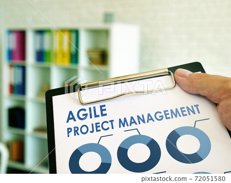 Man reads Agile Project Management information in the book. 72051580