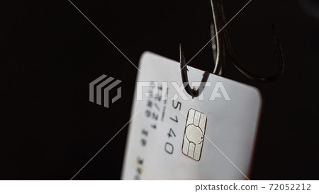 Close-up of a credit card on a fishing hook Close-up of a credit card on a fishing hook 72052212