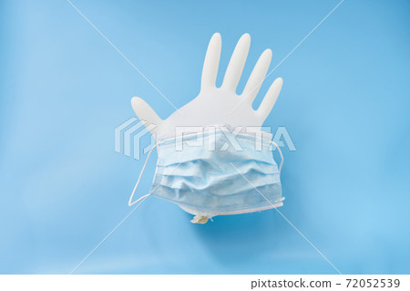 Isolated glove and face mask on a blue background. Stop corona virus 72052539