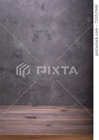 wooden desk table or shelf near grey concrete wall 72052948