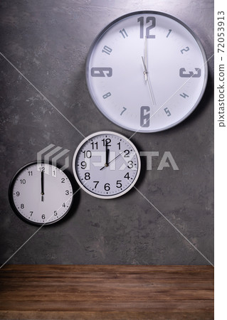 twelve o'clock at wall clock with concrete background twelve o'clock at wall clock with concrete background 72053913