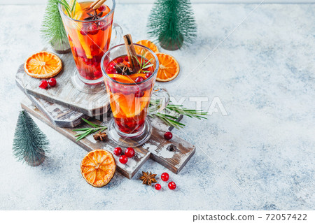 Orange and cranberry drinks with orange slices and spices. Hot drinks for winter and Christmas Orange and cranberry drinks with orange slices and spices. Hot drinks for winter and Christmas 72057422