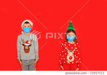 A boy and a girl wearing respiratory masks keep their distance 72057511