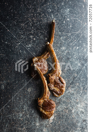 Grilled lamb chops black table. 72057716