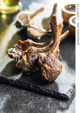 Grilled lamb chops on cutting board. 72057719