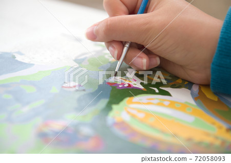 1 - Close up of young female hand painting by numbers. Horizontal 1 - Close up of young female hand painting by numbers. Horizontal 72058093