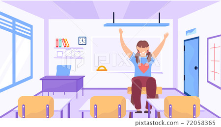 A young girl raises her hand up sitting in empty classroom. The student is ready for entrance exams A young girl raises her hand up sitting in empty classroom. The student is ready for entrance exams 72058365