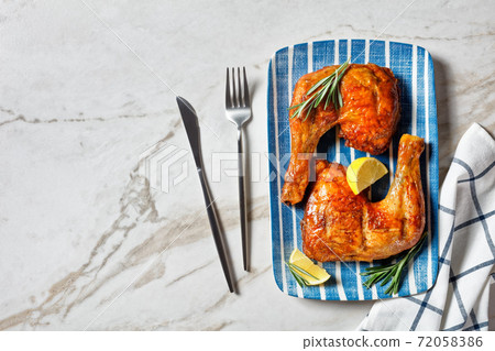 Chicken leg quarters on a plate, copy space Chicken leg quarters on a plate, copy space 72058386