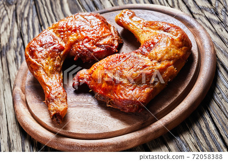 Chicken leg quarters on a wooden background Chicken leg quarters on a wooden background 72058388