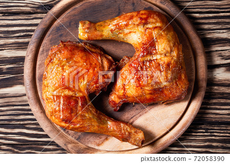 Chicken leg quarters on a wooden background Chicken leg quarters on a wooden background 72058390