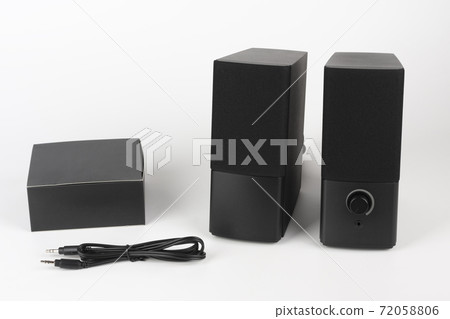 Two computer speakers on white background. Black box with AC adapter and audio cable. 72058806
