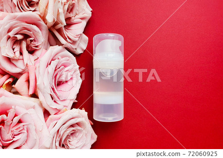 Transparent bottle of Intimate lubricant gel and pink roses on red background. Lifestyle, flatlay, mockup. Bottle for branding and label. Top view. Transparent bottle of Intimate lubricant gel and pink roses on red background. Lifestyle, flatlay, mockup. Bottle for branding and label. Top view. 72060925