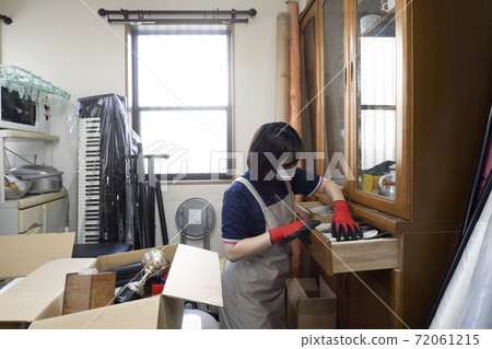 Workers cleaning up cluttered rooms 72061215