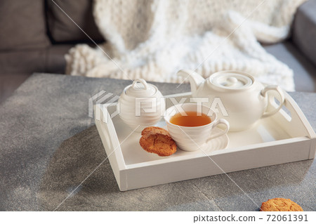 White wooden tray with tea set on grey table. The concept of home atmosphere and comfort. 72061391