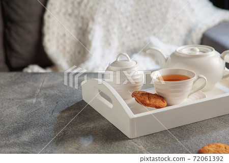 White wooden tray with tea set on grey table. The concept of home atmosphere and comfort. 72061392