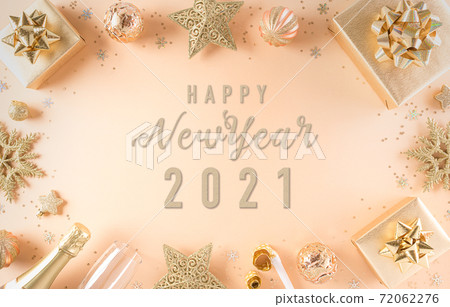 Merry Christmas and New year celebration concept. Golden gift box, stars and christmas ball on pastel background. Flat lay, top view happy new year text. 72062276