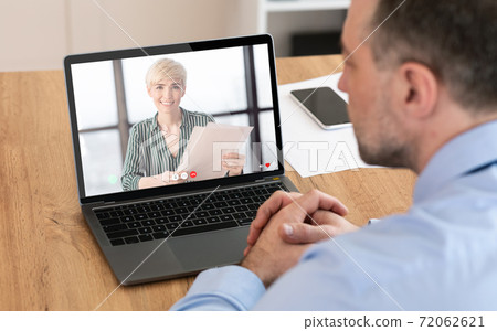 Unrecognizable man having videocall with his business partner, using laptop 72062621