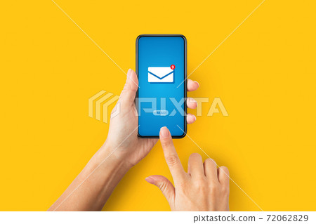 Online correspondence. Top view of young lady pressing READ button on cellphone with incoming email, orange background Online correspondence. Top view of young lady pressing READ button on cellphone with incoming email, orange background 72062829