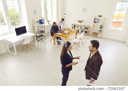 Young people meeting in modern office space, communicating and working on business projects 72063167