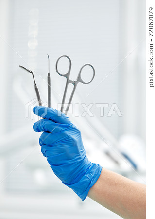 Close-up of dentist's hands and dental equipment 72067079