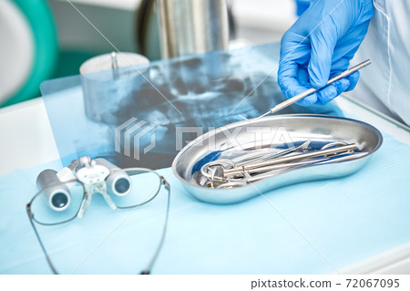 Close-up of dentist's hands and dental equipment Close-up of dentist's hands and dental equipment 72067095