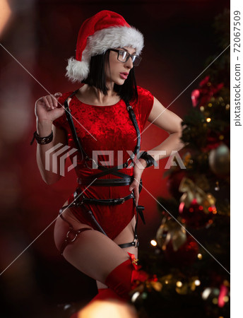 a woman in a red Christmas bodysuit and Santa hat with a leather belt and a belt belt a woman in a red Christmas bodysuit and Santa hat with a leather belt and a belt belt 72067509