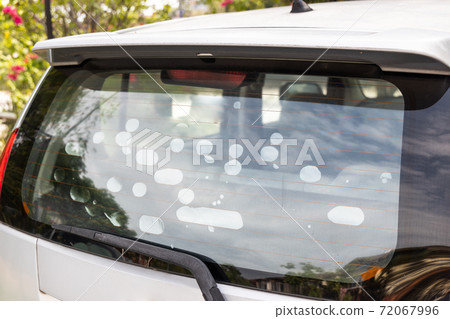 Bubble formed on car rear glass wind screen tint film suggest inferior quality 72067996