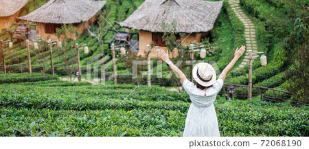 Happy tourist woman in white dress enjoy beautiful Tea garden.Traveler visiting in Ban Rak Thai village, Mae Hong Son, Thailand. travel, vacation and holiday concept Happy tourist woman in white dress enjoy beautiful Tea garden.Traveler visiting in Ban Rak Thai village, Mae Hong Son, Thailand. travel, vacation and holiday concept 72068190