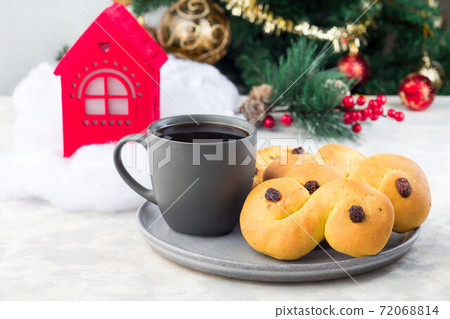 Traditional Swedish and scandinavian Christmas saffron buns Lussekatter with cup of coffee, Christmas decoration on background, horizontal Traditional Swedish and scandinavian Christmas saffron buns Lussekatter with cup of coffee, Christmas decoration on background, horizontal 72068814