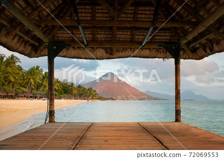 Flic en Flac beach and the mountain Tourelle du Tamarin at sunset 72069553
