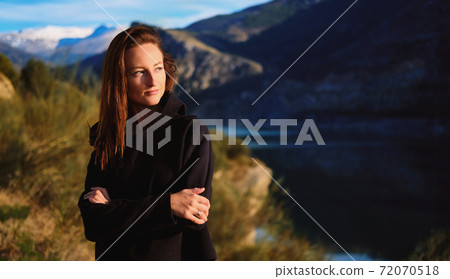 Woman posing on mountainous background 72070518