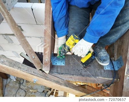 master screwdriver screwdriver screw into a wooden board 72070637