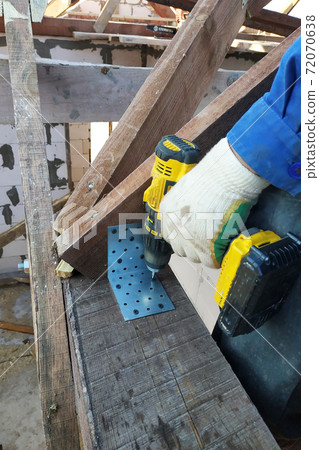 master screwdriver screwdriver screw into a wooden board 72070638